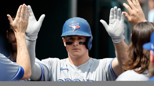 Jul 9, 2023; Detroit, Michigan, USA; Toronto Blue Jays third baseman Matt Chapman (26) receives congratulations from teammates after scoring in the seventh inning against the Detroit Tigers at Comerica Park. Mandatory Credit: Rick Osentoski-USA TODAY Sports